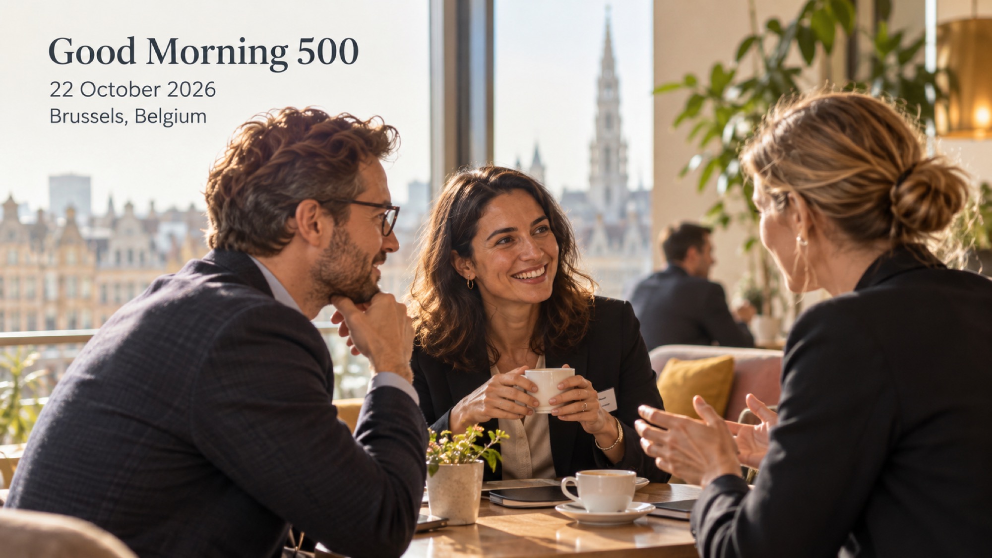 Three professionals talking over coffee in a bright business lounge.