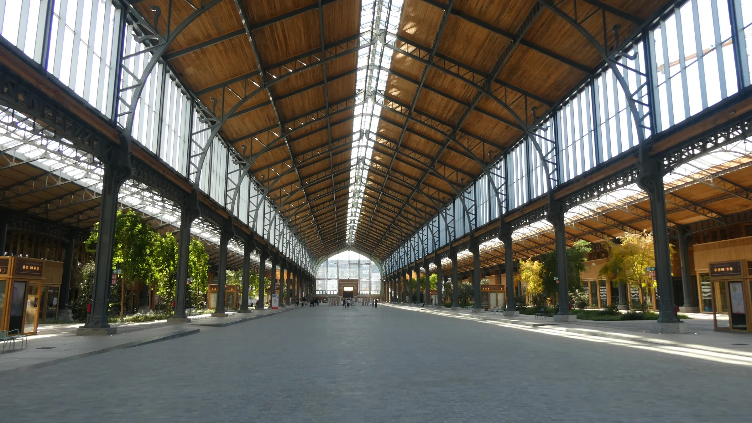 Steel columns and a long glazed roof above the renewed Gare Maritime interior in Brussels.